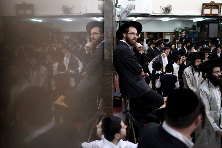 24 hours in pictures:  Ultra Orthodox Jewish man reflected on the wall 