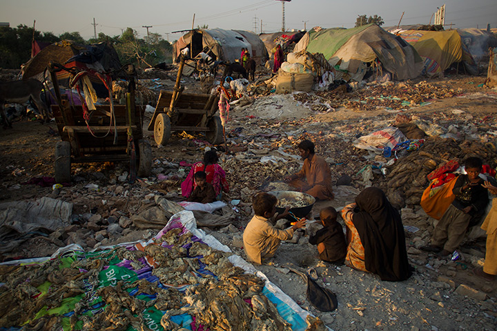 24 hours: Rawalpindi, Pakistan: Members of a nomad community sort out animal fats 