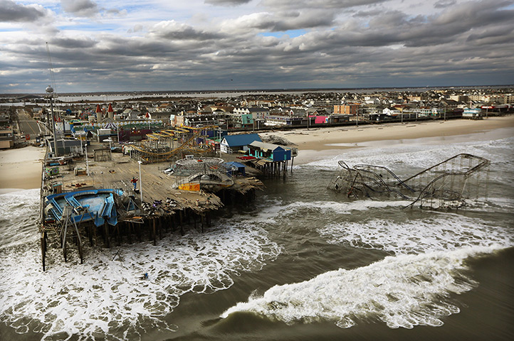 From the agencies: Waves break in front of a destroyed amusement park