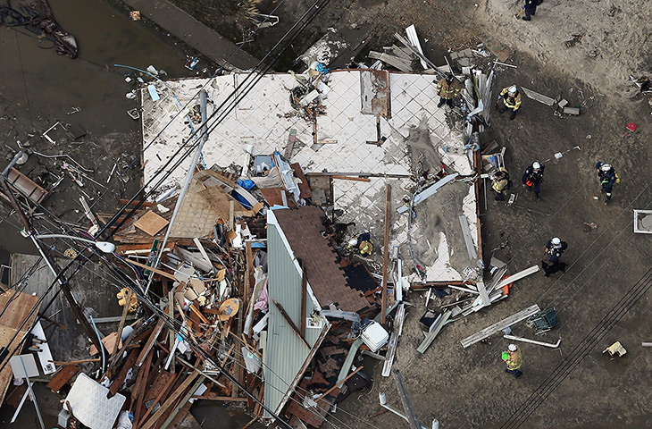 From the agencies: Rescue workers gather around a house wrecked in Seaside Heights, New Jersey