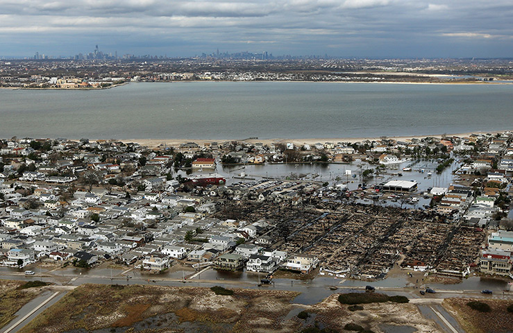 From the agencies: The remains of burned homes are surrounded by water, Queens