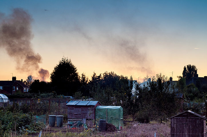 Your Pictures: Alight: Smoke from garden fires in the distance behind an allotment.