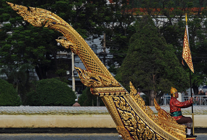 24 hours: A Thai Navy oarsman sits at the back of a barge