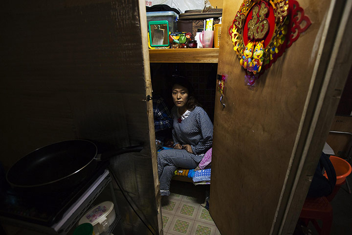 20 Photos: Li Rong on a bed in her cramped living space in Hong Kong