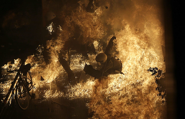 20 Photos: A riot police officer is engulfed by petrol bomb flames in Athens