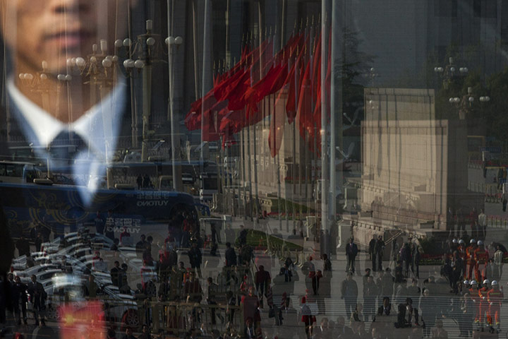 20 Photos: People are reflected in a door of the Great Hall of the People in Beijing