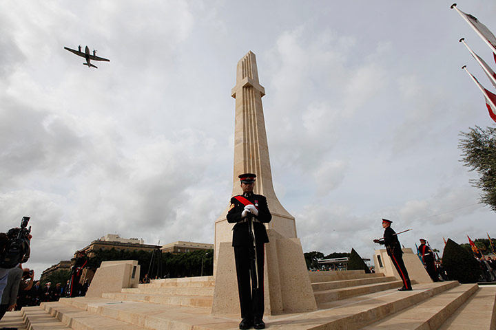 Remembrance Day: Valletta, Malta: An army aircraft flys over the War Memorial cenotaph