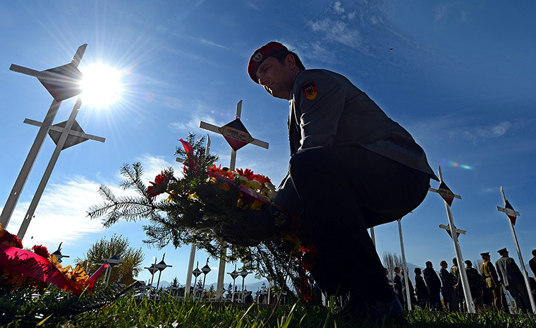 24 hours: Bitola, Macedonia: A German soldier lays a wreath next to graves