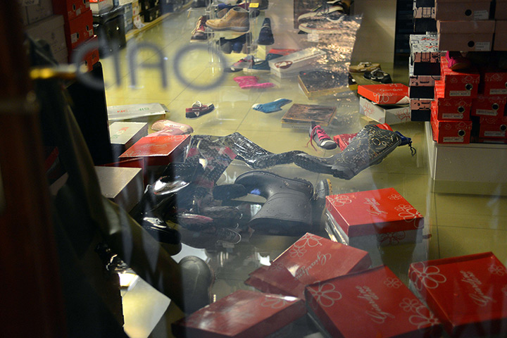 Venice floods: Shoes and wellies float in a flooded shop