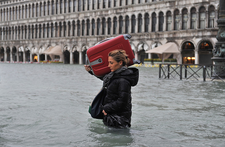 Venice floods: A tourist crosses flooded St Mark's Square