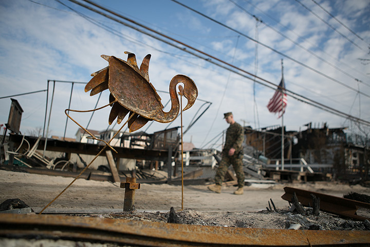 24 hours: New York State, US: A uniformed officer walks through Breezy Point