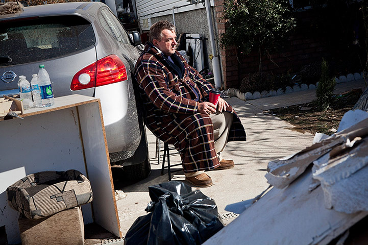 Hurricane Sandy clean-up: A man takes in the aftermath of Hurricane Sandy on Staten Island