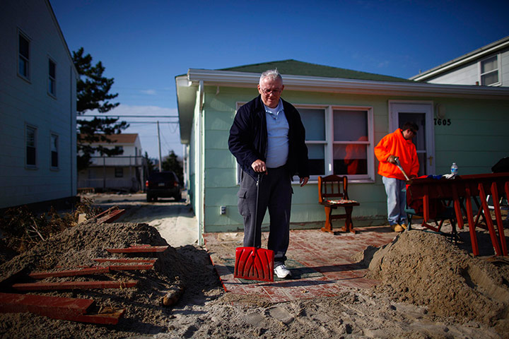 Hurricane Sandy clean-up: Residents shovel sand from a home on Long Beach Island, New Jersey