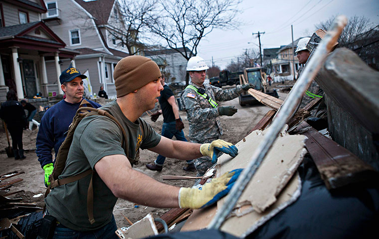Hurricane Sandy clean-up: A volunteer helps clean-up a home destroyed by Hurricane Sandy