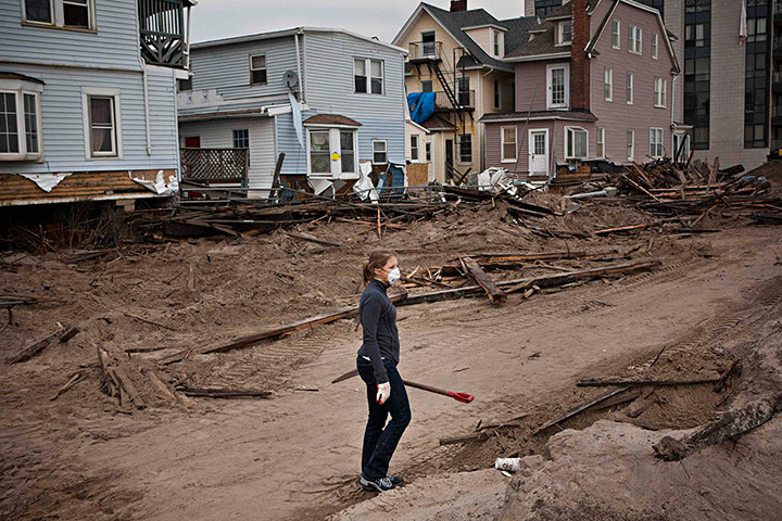 Hurricane Sandy clean-up: A volunteer holds a shovel, Rockaway Beach, Queens