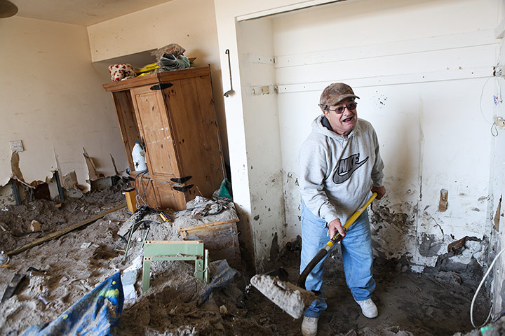 Hurricane Sandy clean-up: Carlos Yera helps his son dig through the many feet of sand