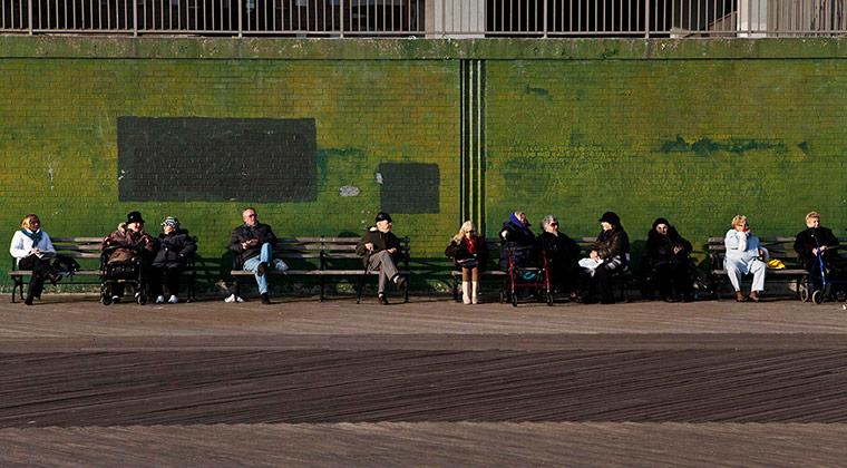 24 hours in pictures: People sit along the Brighton beach boardwalk