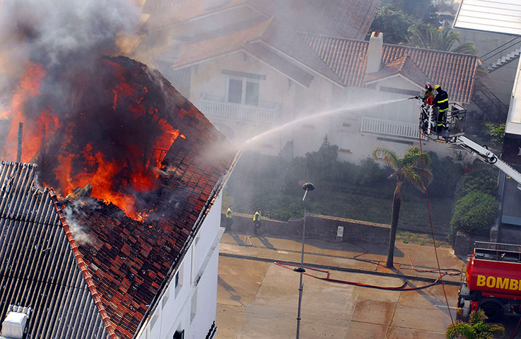 24 hours in pictures: Fire fighters try to extinguish a fire 