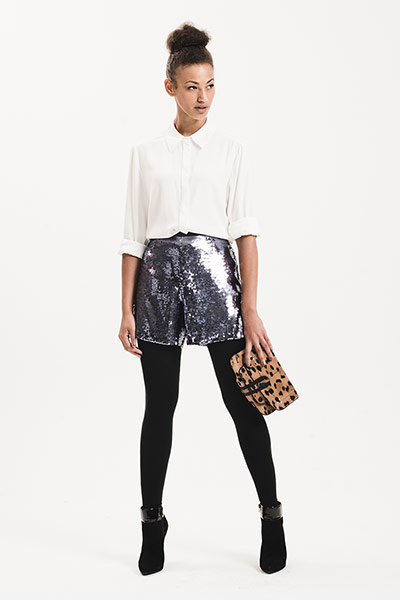 All Ages: Shiny: model wears sequined sliver/blue shorts and white shirt