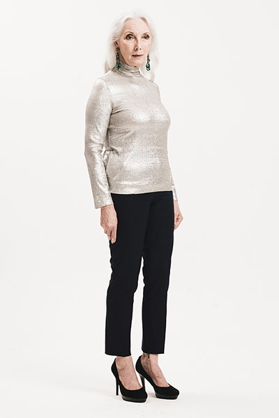 All Ages: Shiny: model wears silver polo-neck and black trousers