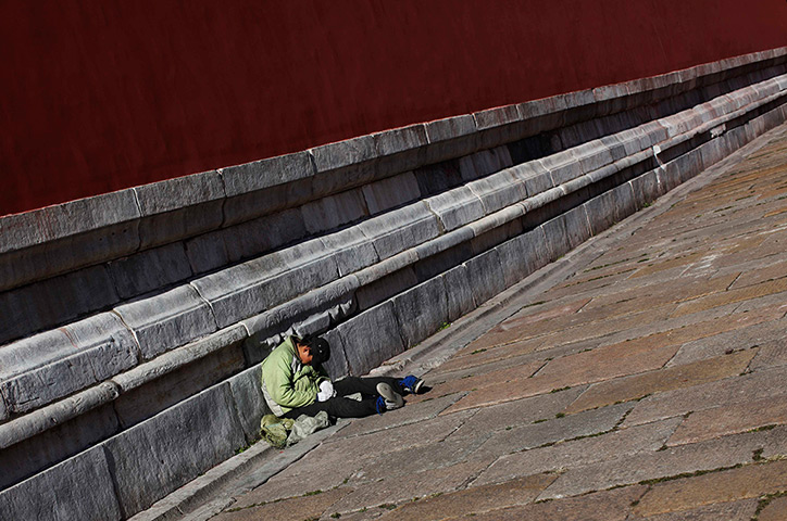 Carlos Barria China: A man sleeps inside the Forbidden City