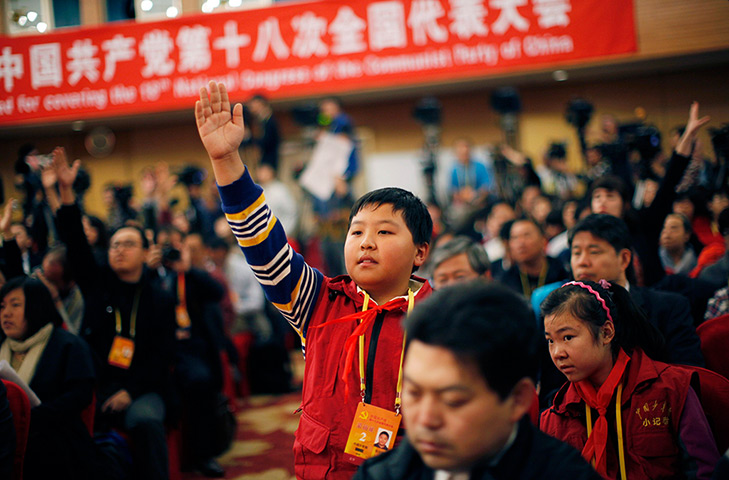 Carlos Barria China: Zhang Jiahe, from the Chinese Teenagers News, raises his hand