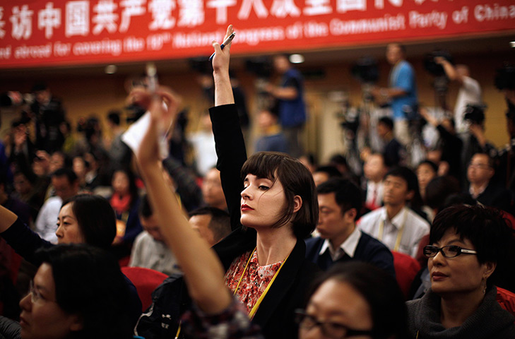 Carlos Barria China: A foreign journalist raises her hand to ask a question during conference