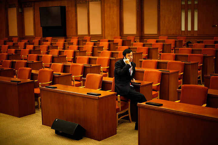 Carlos Barria China: A man talks on the phone at The Great Hall of the People
