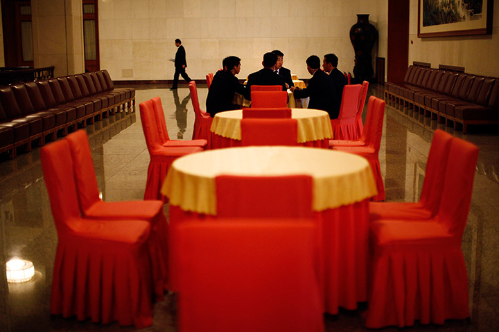 Carlos Barria China: Staff members sit around a table as they take a break