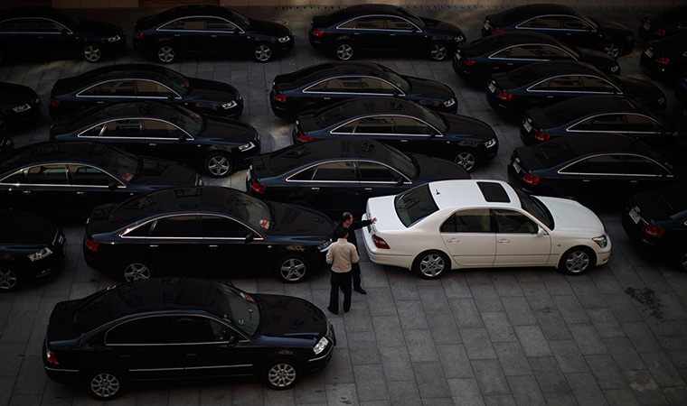 Carlos Barria China: Drivers of government cars chat at a parking lot 