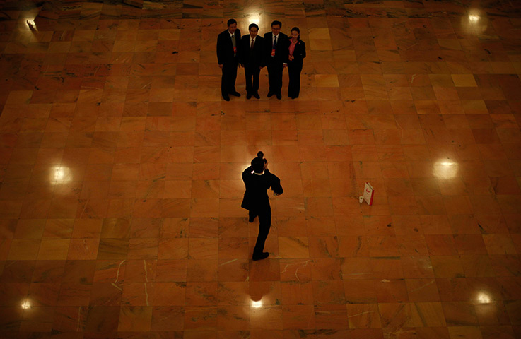 Carlos Barria China: Staff pose for pictures inside the Great Hall of the People