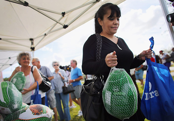 24 hours in pictures: Thanksgiving turkey charity give-away
