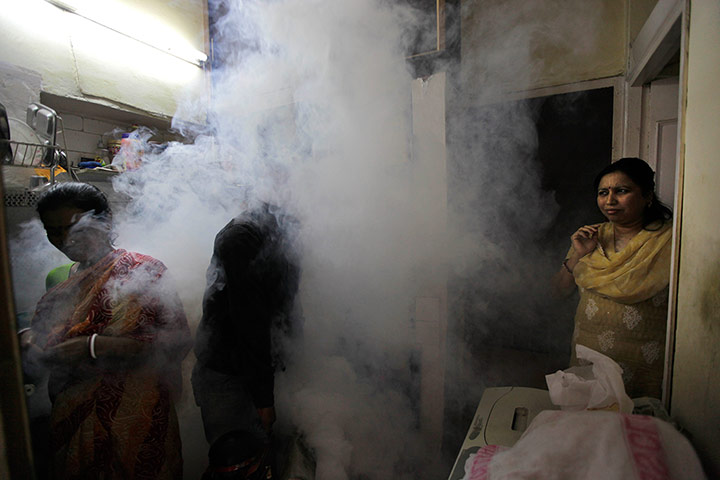 Dengue epidemic: A Delhi Municipal field worker fumigates in an area of New Delhi, India