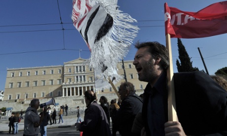 Protesters chant slogans during an anti-austerity protest outside the Greek parliament in Athens on November 14, 2012. 