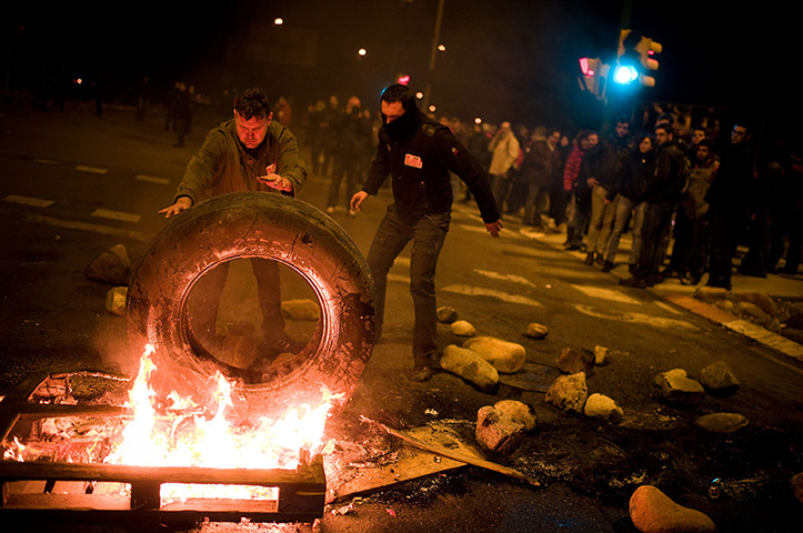 Euro protests: Barcelona, Spain:  Demonstrators set up a barricade of burning tyres
