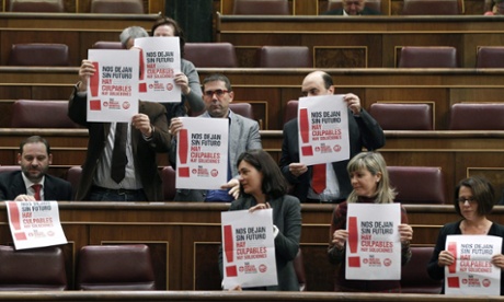 Main opposition Socialist party PSOE's parliamentarians hold posters supporting the general strike during a plenary session at the Lower Chamber in the Spanish Parliament, in Madrid, Spain, 14 November 2012