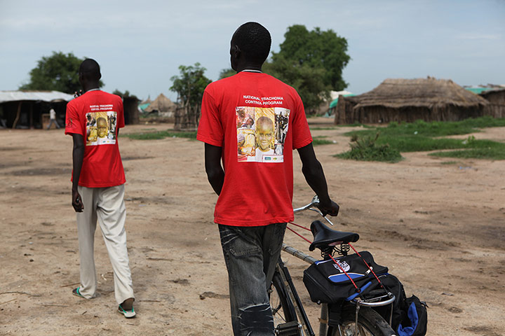 Malaria Consortium: Malaria Consortium Community Drug Distributors arriving on donated bicycles