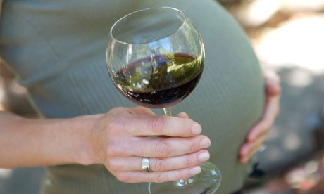 Pregnant woman with glass of wine