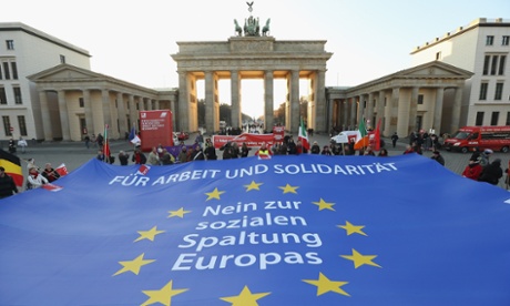 Berlin: Protesters demonstrating in solidarity with the economically-stricken nations of southern Europe hold taut a giant flag of the European Union with slogans that read: 