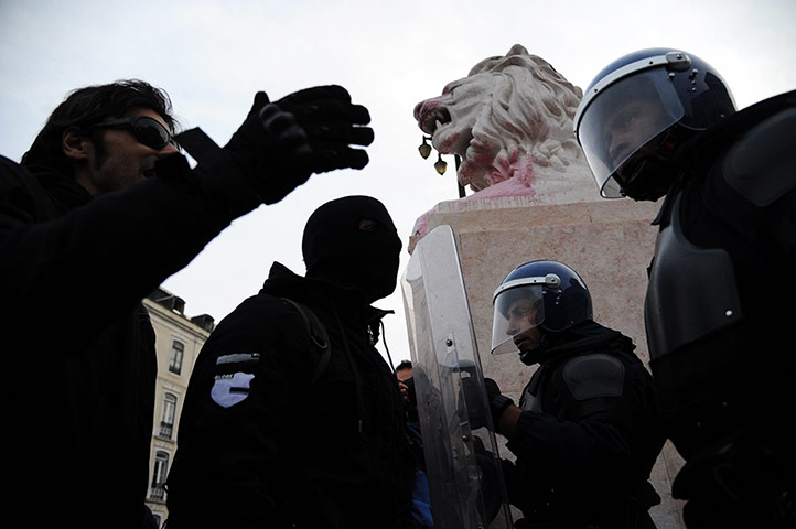 Europe protests: Riot police face protesters outside the Portuguese Parliament in Lisbon