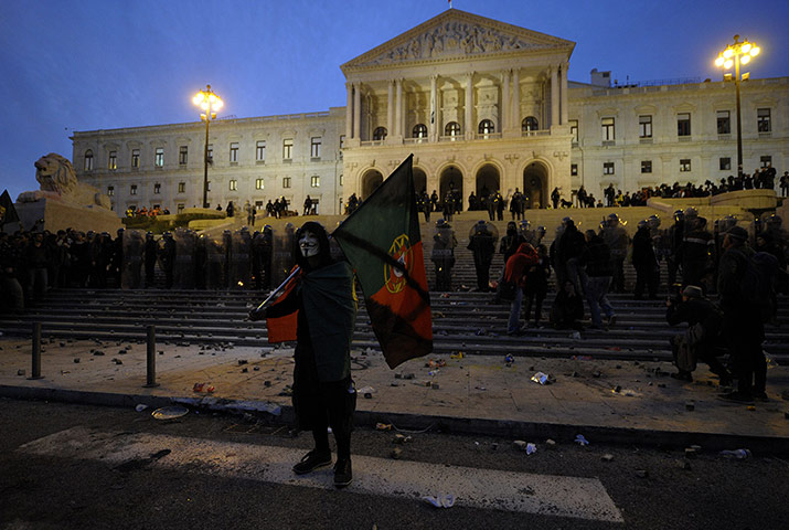 Europe protests: A protester wearing a Guy Fawkes mask an