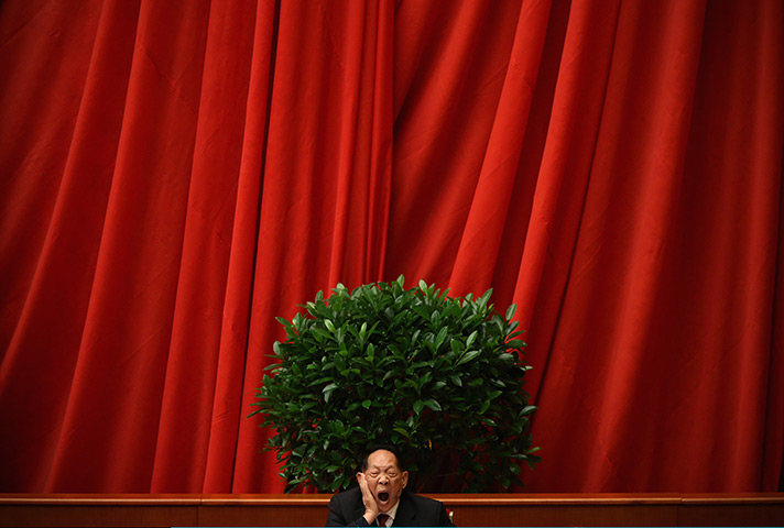 24 hours in pictures: China: A scientist delegate yawns at stage 