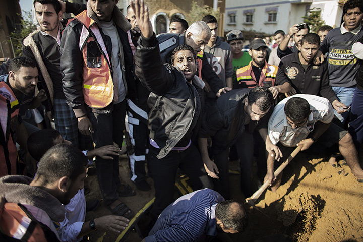 Gaza and Israeli strikes: A Palestinian man calls for help as he and others try to save a man