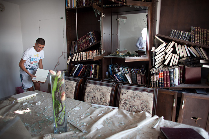 Gaza and Israeli strikes: Kiryat Malachi, Israel: An Israeli youth gathers holy Jewish books