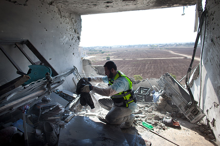 Gaza and Israeli strikes: Kiryat Malachi, Israel: An Israeli emergency serviceman clears an apartment