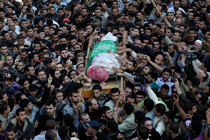 Gaza and Israeli strikes: Gaza City: Palestinian Hamas members carry the body of Ahmed al-Jabari 