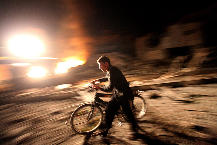 Gaza and Israeli strikes: Gaza City: A Palestinian passes by a destroyed Hamas site 