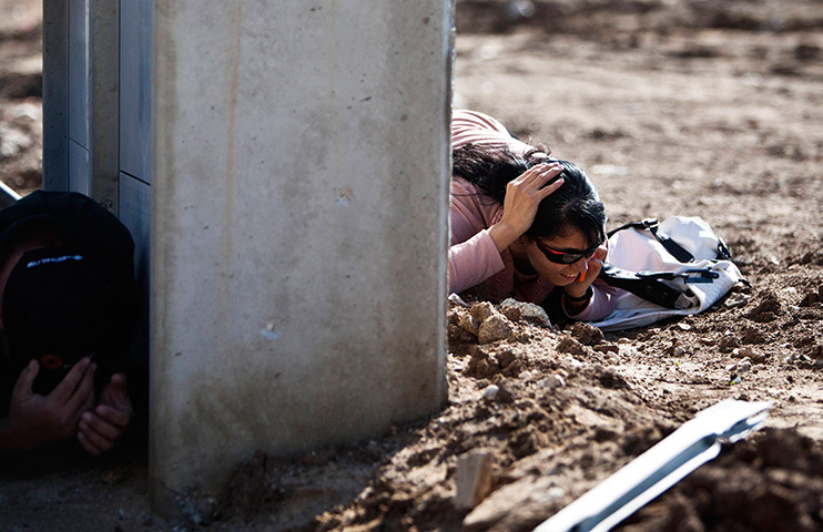 Gaza and Israeli strikes: Kiryat Malachi, Israel: Israelis take cover as a siren sounds