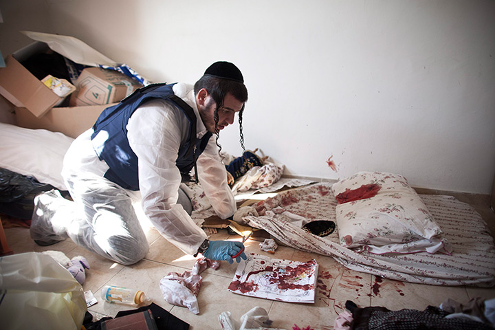 Gaza and Israeli strikes: Kiryat Malachi, Israel: A Zaka volunteer cleans blood stains