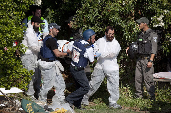 Gaza and Israeli strikes: Sderot, Israel: Rescue workers evacuate victims bodies